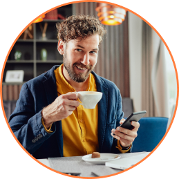 Boy enjoying coffee with phone in hand - Mobile Loyalty App